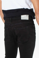 alt="Francisco Tolli black carrot denim jeans back view"