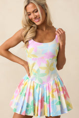 The pleated skirt on this pastel mini dress adds playful movement while concealing comfortable built-in shorts.