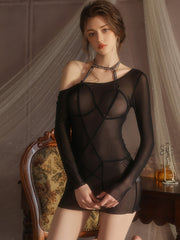 Woman wearing a black sheer outfit in an elegant room setting.