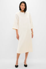 Winter White Side Button Jamie Dress: A classic, effortless midi with elbow-length sleeves and side ties, paired with black pumps and gold jewelry for a fun, high-end look.