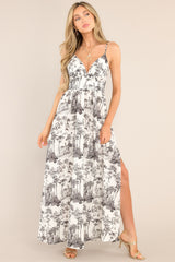 Front view of this dress that features a v-neckline, thin adjustable straps, a smocked insert in the back, a fitted waistband, and a side slit.