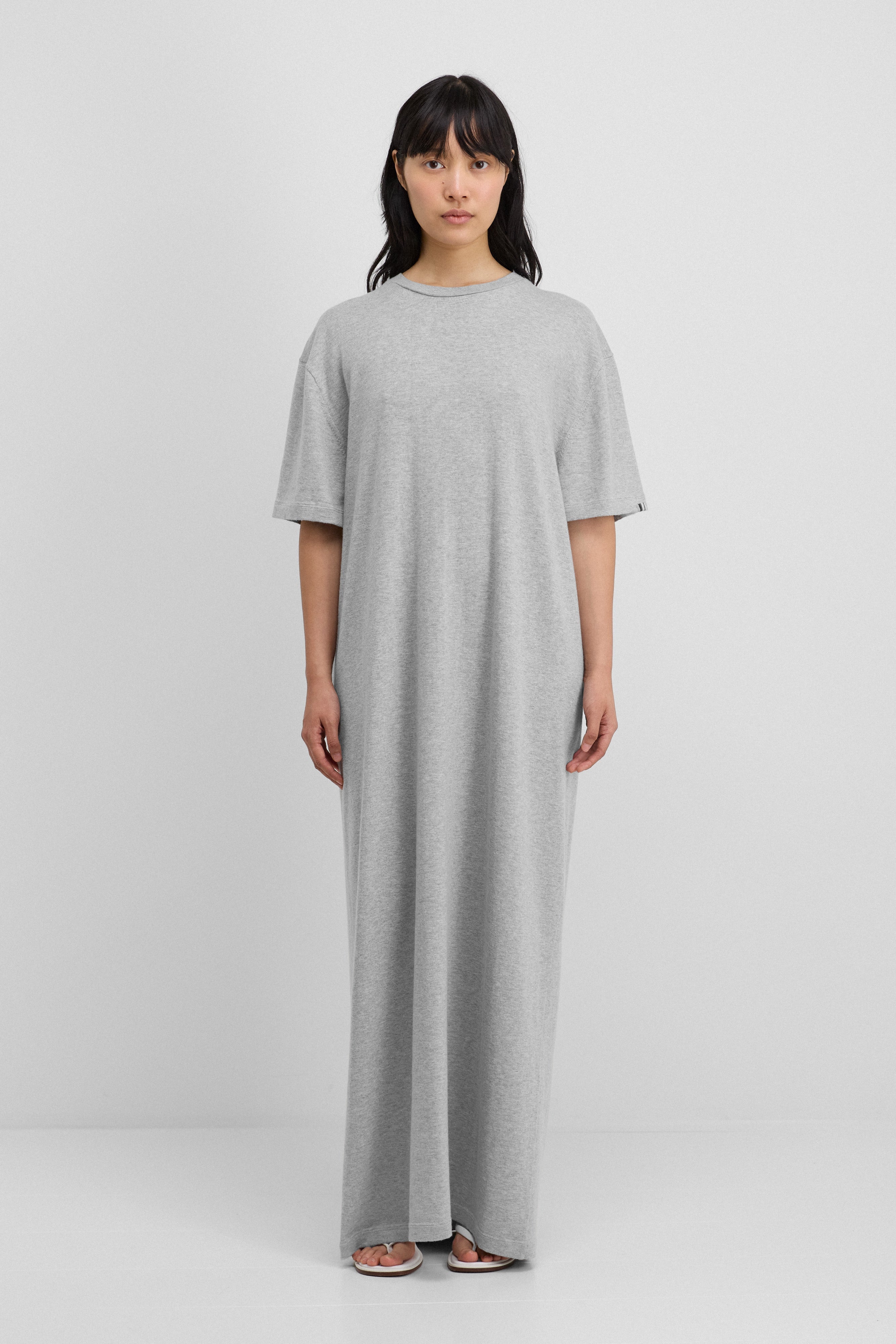 woman wearing a grey floor-length cotton cashmere t-shirt dress.