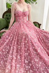 Romantic blush pink gown with 3D floral straps, fitted corset bustier, and flowing sequin tulle skirt for prom evening gala