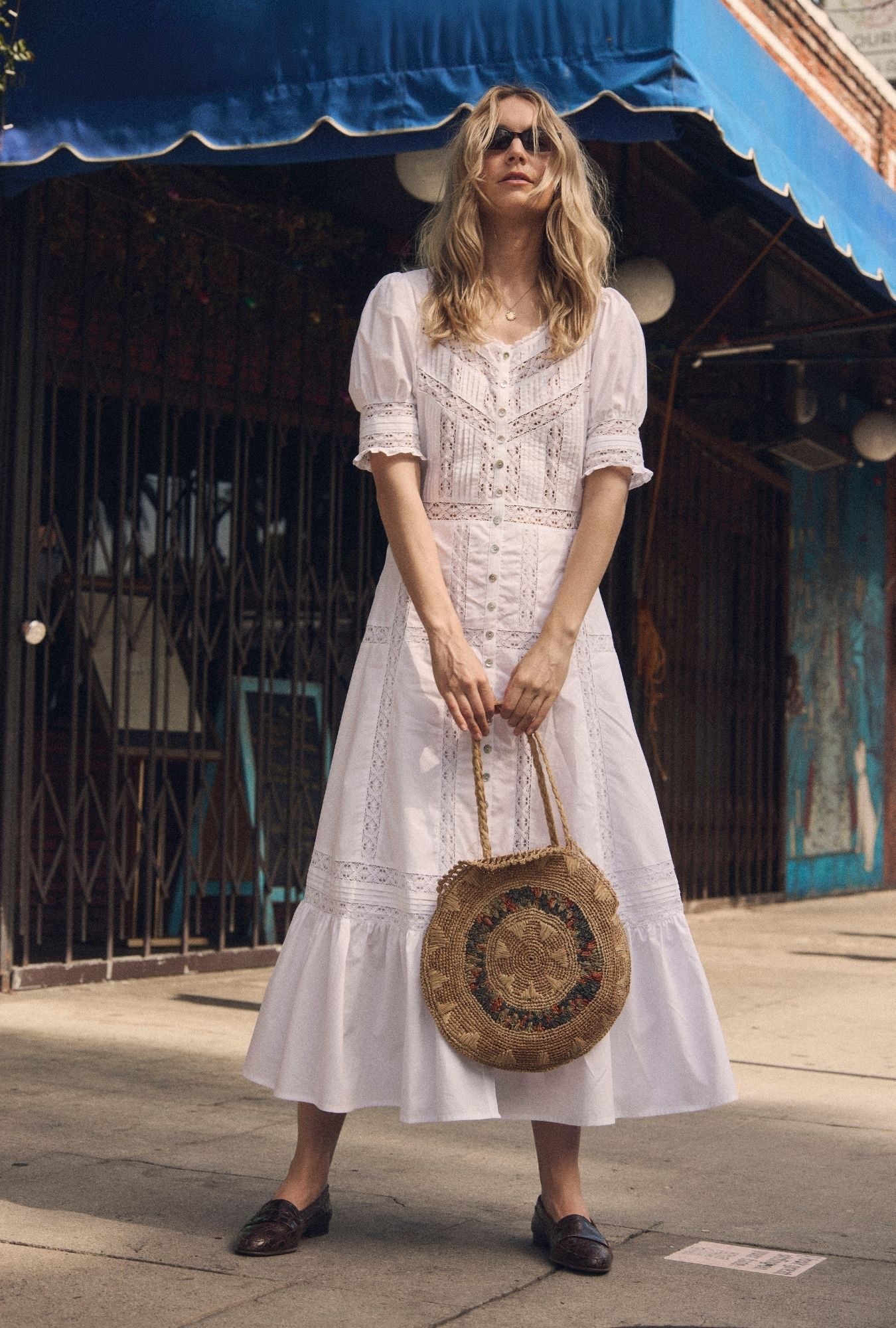 A lady wearing The "Lucia" Soft White Cotton Maxi Dress