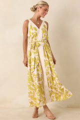 Light green and ivory floral dress with V-neckline and flowing skirt.