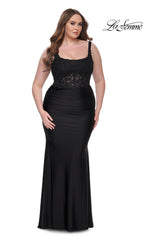 A woman models the La Femme Long Prom Dress 31273, featuring a black lace bodice and fitted skirt, against a plain white background. The "La Femme" logo appears in the top right corner.