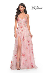 A woman wears the La Femme Floral-Sequin Long A-Line Prom Dress 32031, featuring pink floral sequins and a thigh-high slit, standing against a white background with the "La Femme" logo in the top right corner.