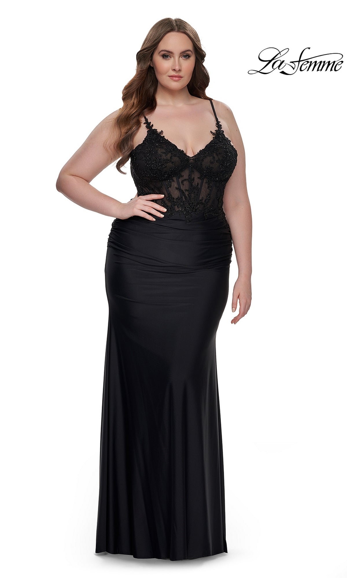 A woman models the La Femme Plus-Size Long Black Prom Dress 32226, featuring an embroidered-lace bodice and thin straps, standing against a plain white background. The La Femme logo is displayed in the top right corner.