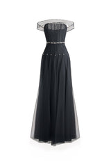 Black off-shoulder organza maxi dress from Happy Clothing, flowing elegant design with ruffled neckline and full-length skirt.