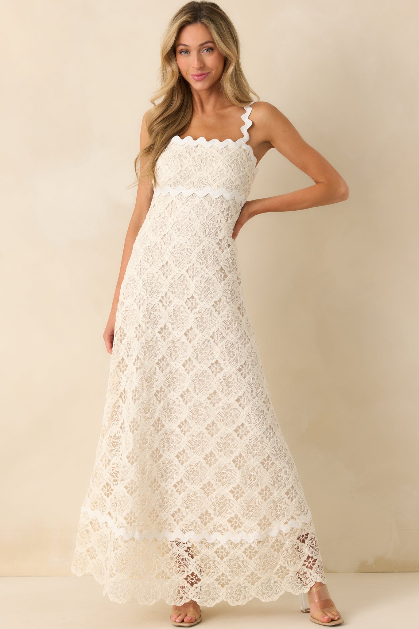Full length shot of the maxi dress highlighting the ivory lining beneath the lace overlay and the scalloped edge created by the ric rac trim.