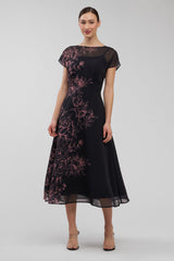 Black dress with pink floral embroidery on a white background
