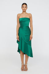 Woman wearing a green strapless dress on a white background
