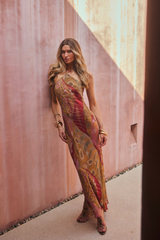 Model wearing the 12th Tribe Isabella Patchwork Maxi Dress, a halter tie-back maxi dress in a sheer, lightweight bias-cut chiffon with patchwork detailing and back neckline gripper tape, perfect for summer soirées, festival-ready looks, and effortless vacation styling