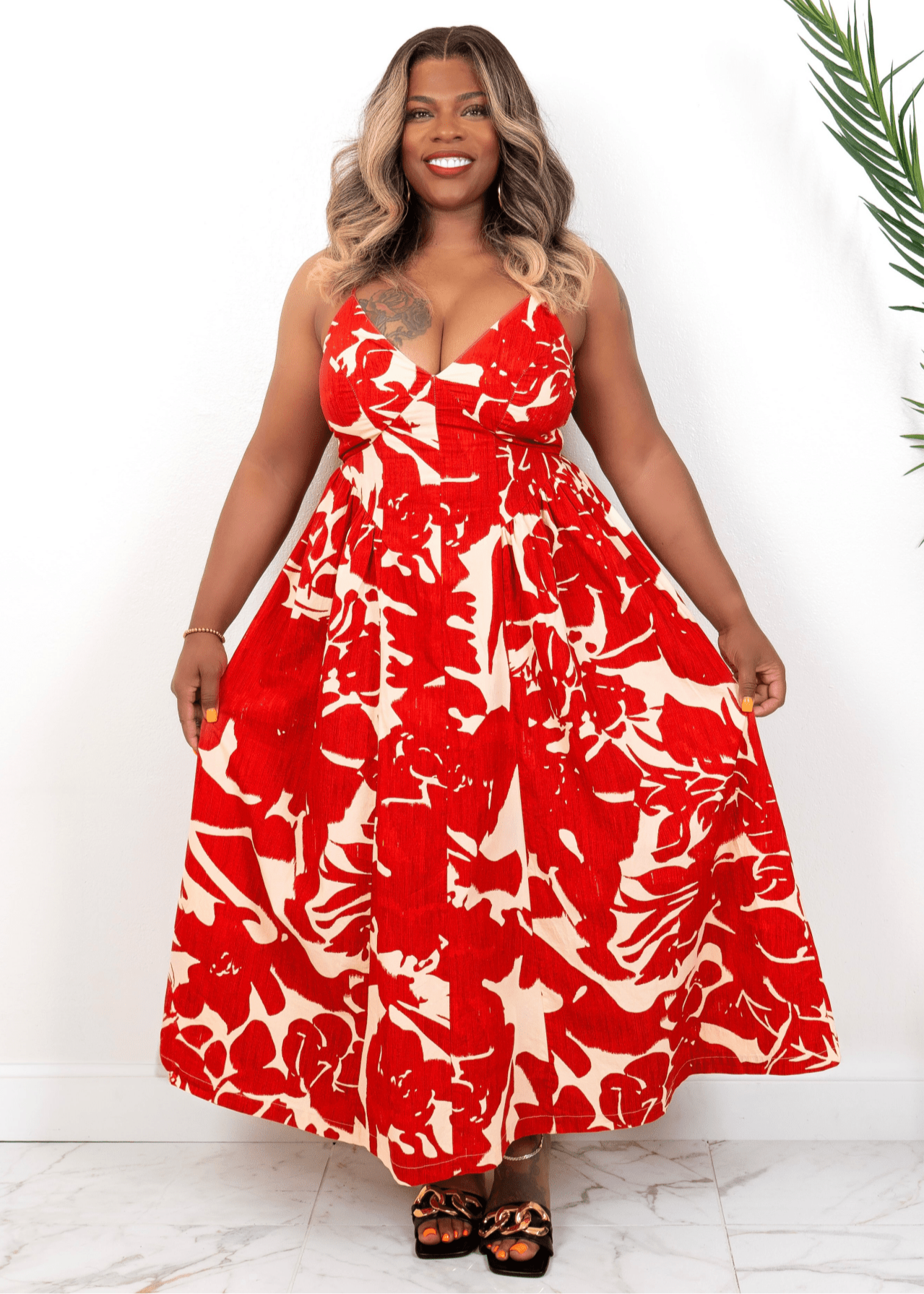 Front view of red floral maxi dress on curvy model – bold summer vacation dress from Opulent Gurlz
