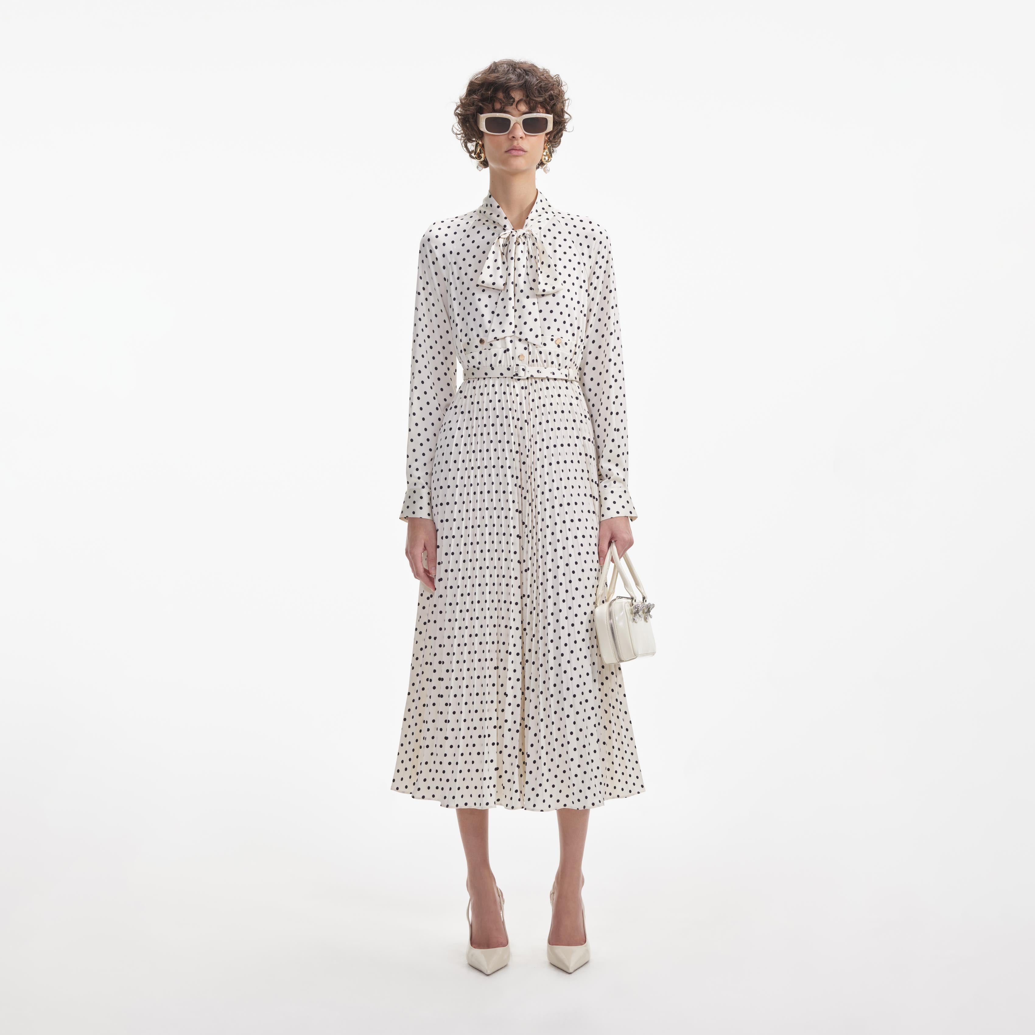 Front view of a woman wearing the Cream Polka Dot Satin Midi Dress