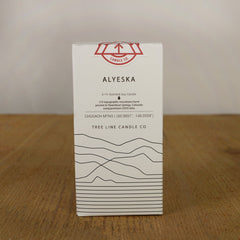 A white box with black lettering and a red and white Tree Line Candle Co. logo.