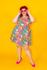 Red-haired model in bright colored 80s inspired fit & flare dress with zipper