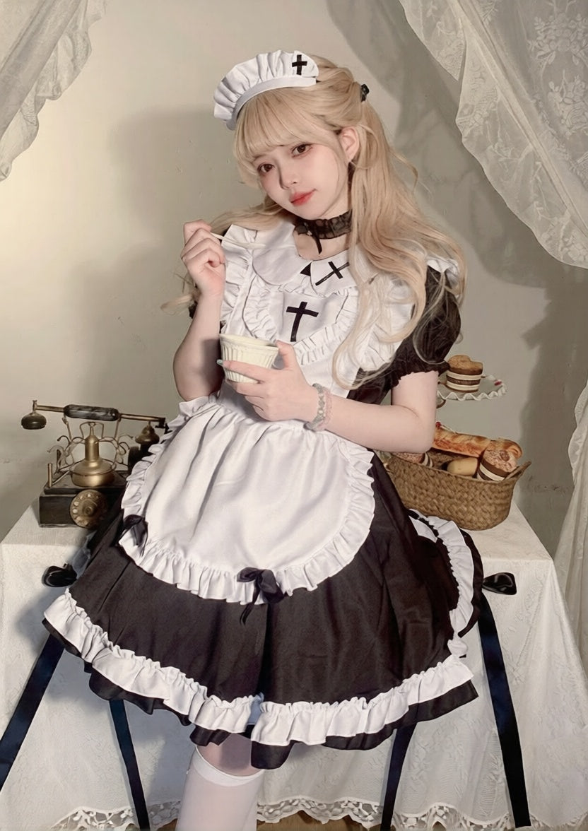 Person in a maid outfit sitting at a table with a vintage scale and basket.