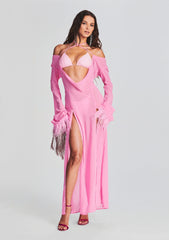 Model wearing pink Ciara Dress with off shoulder sleeves and a high front slit over a pink bikini top.
