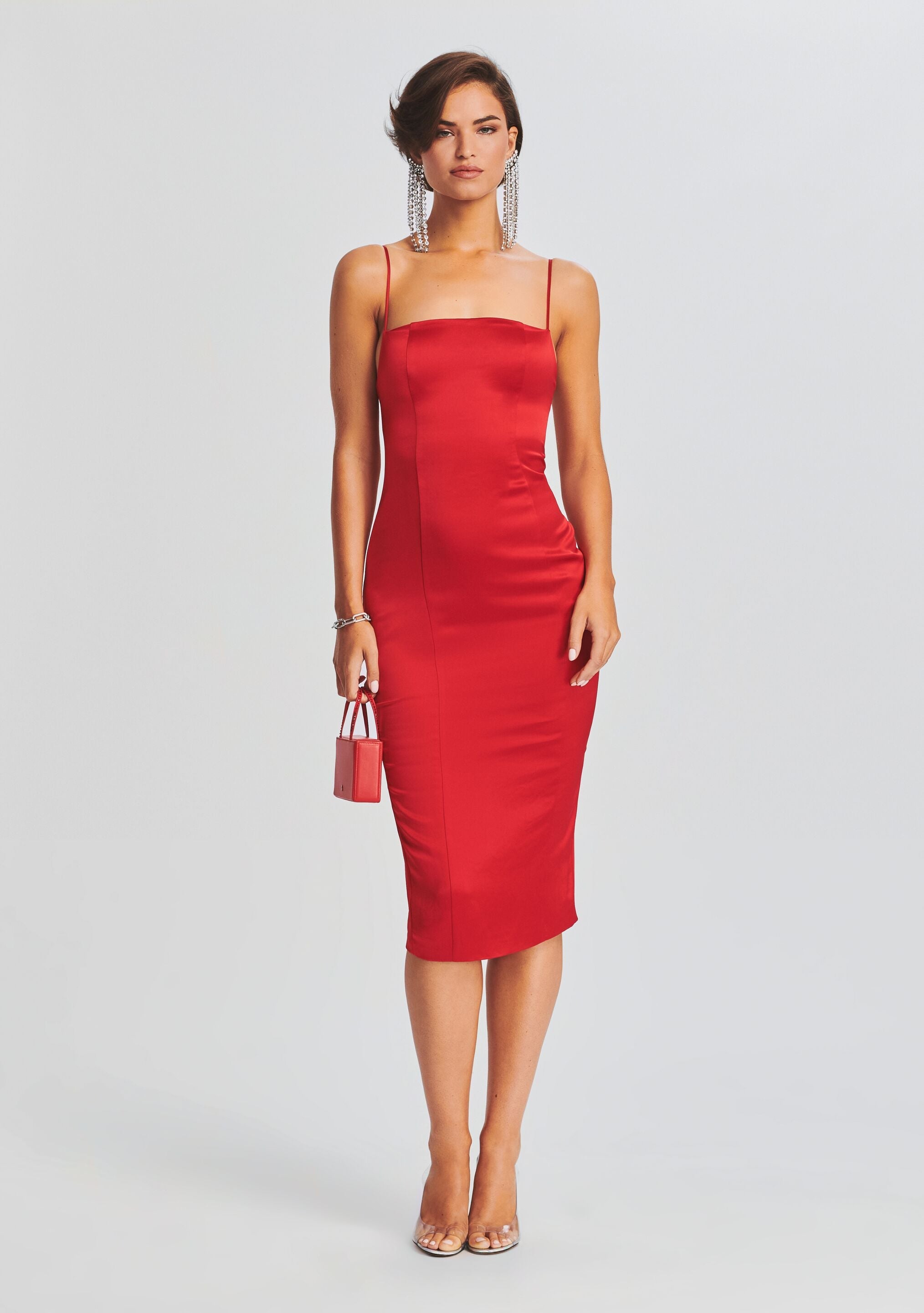 Red satin midi dress with thin shoulder straps and a sleek fitted silhouette