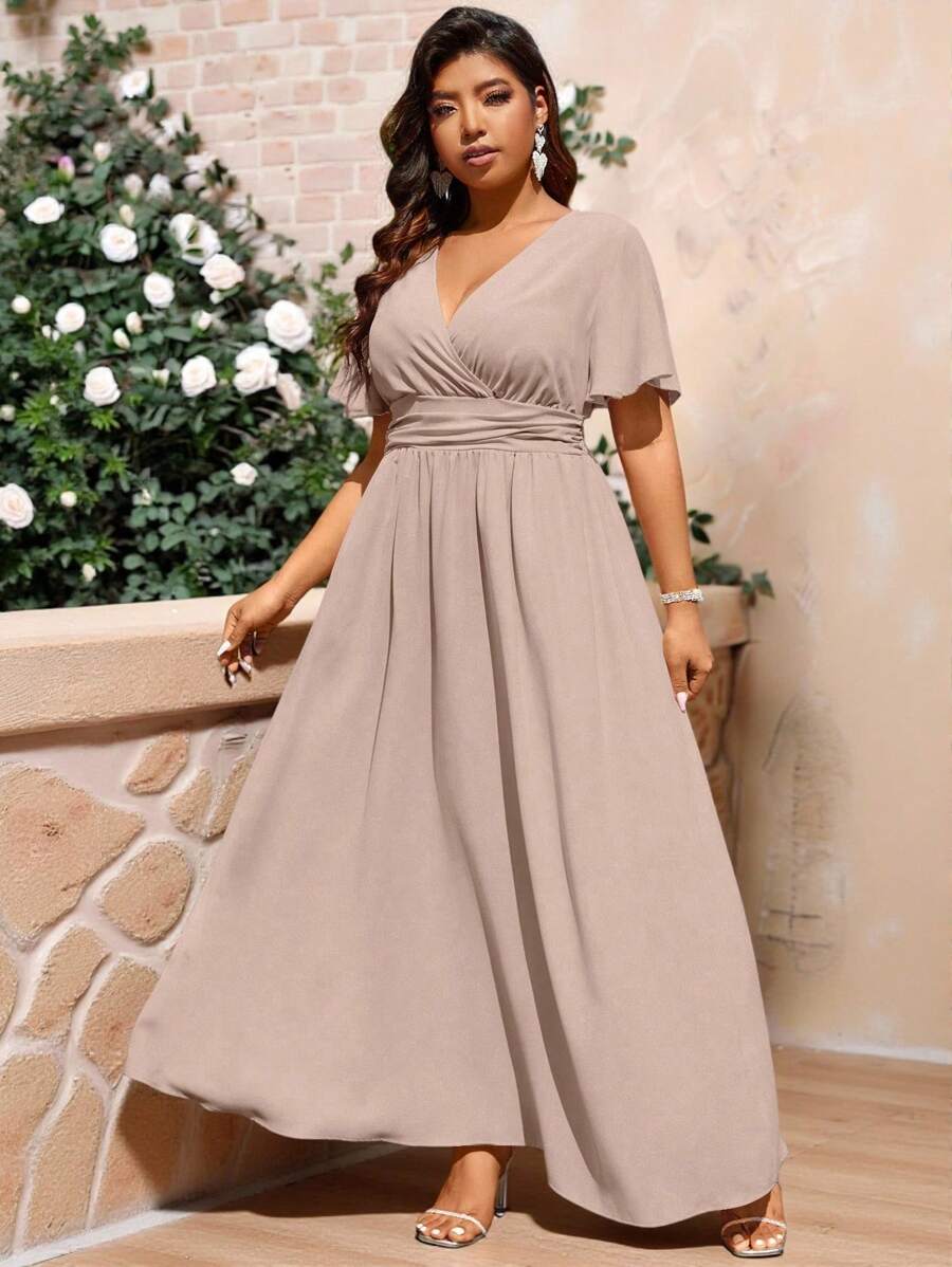 Step into summer with this Elegant Plus Size Maxi Dress designed to embrace your curves with style. Featuring a flirty overlapping V-neck and gentle ruffles, it brings a playful charm to your look. The pleated waist adds a flattering silhouette while keeping comfort front and center. Perfect for sunny days and evening gatherings, this dress blends elegance and ease in one beautiful package.