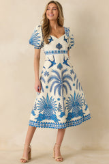 Full front view of blue and ivory midi dress with tropical print and sweetheart neckline.