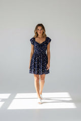Flowy off-shoulder mini dress with front tie detail.