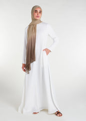 Long Line Abaya in Classic White, featuring a flattering silhouette that effortlessly complements your style. Experience comfort and sophistication in every step with this must-have addition to your modest collection.
