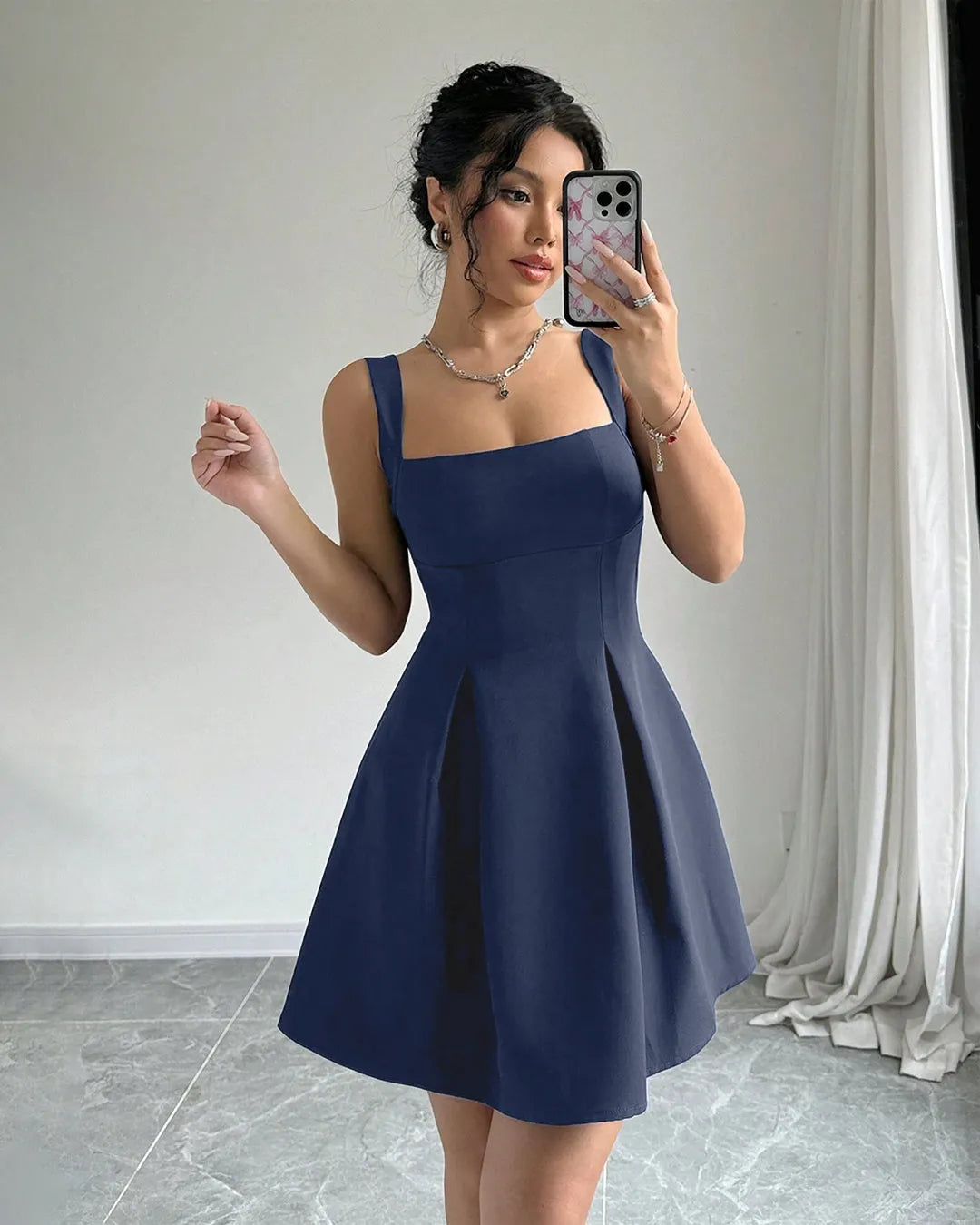 Navy blue sleeveless mini dress with a square neckline and a fit-and-flare silhouette.