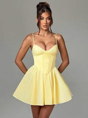 Yellow boned corset bodice dress with spaghetti straps, cinched waist, and short flared A-line skirt.
