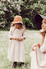 Soft pink girls muslin dress with 3/4 sleeves made with organic cotton. This sustainable girls dress is good for eczema prone skin. Mini Me fashion available.