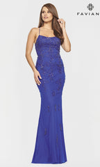 A woman wears the Strappy Open-Back Long Yellow Faviana Prom Dress, featuring spaghetti straps and a sleek silhouette, standing against a plain background with the Faviana logo in the top right corner.