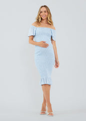 ||A pregnant woman wearing a blue off-the-shoulder smocked midi dress with flutter sleeves and a flirty hem.