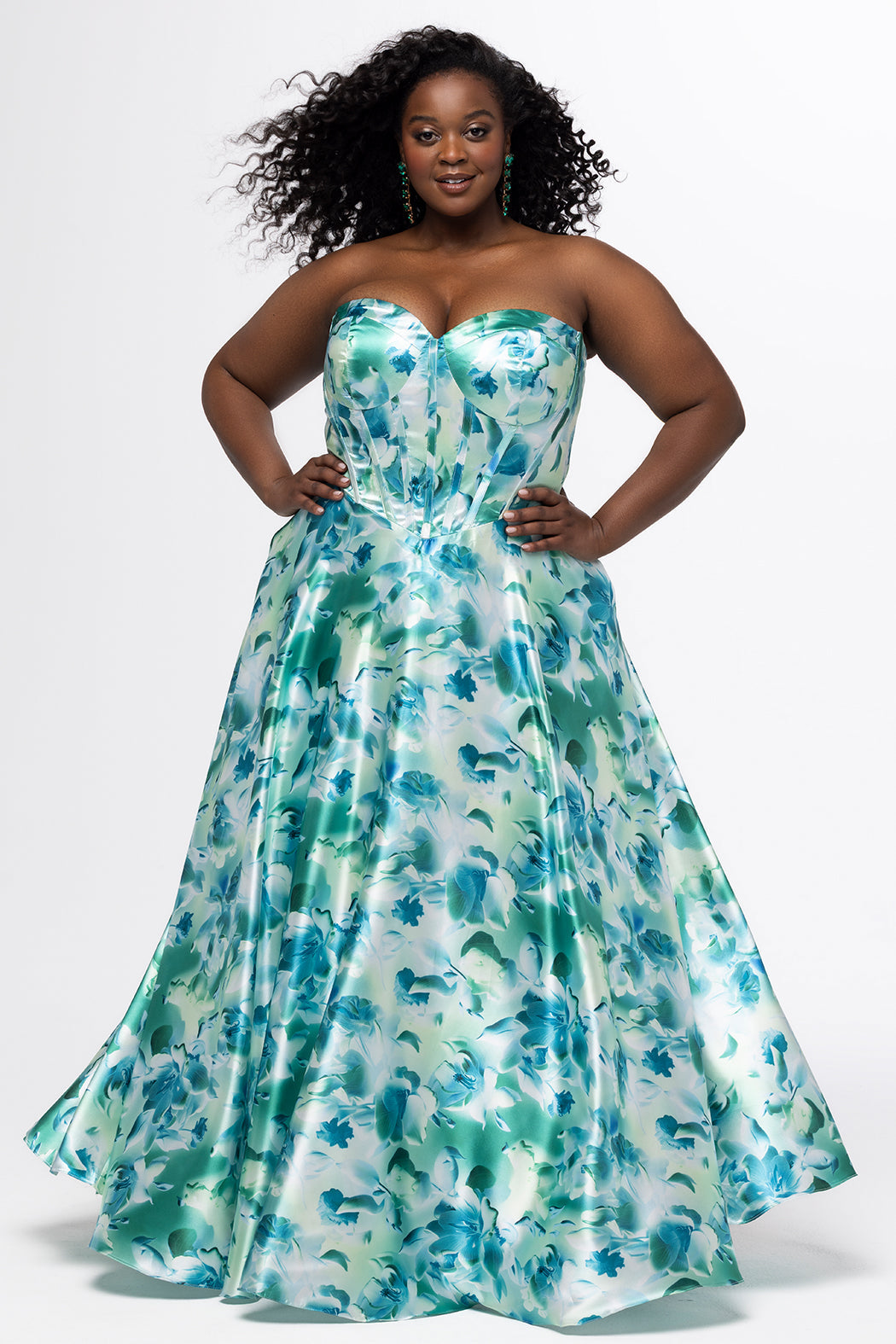 SC7435 green and blue floral print satin gown from Sydney's Closet.
Strapless, sweetheart neckline, exposed corset boning, Basque waistline, A-line skirt with pockets and center back zipper.
Trendy multi-colored floral print formal dress.