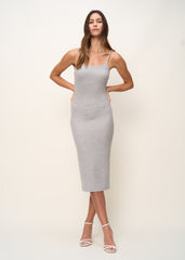 Woman in comfortably form fitted, spaghetti strap midi dress including a back slip and built-in shelf bra made of mid-weight and soft Tencel™ Lyocell stretch rib fabric and eco-friendly dyes in color heather grey, front