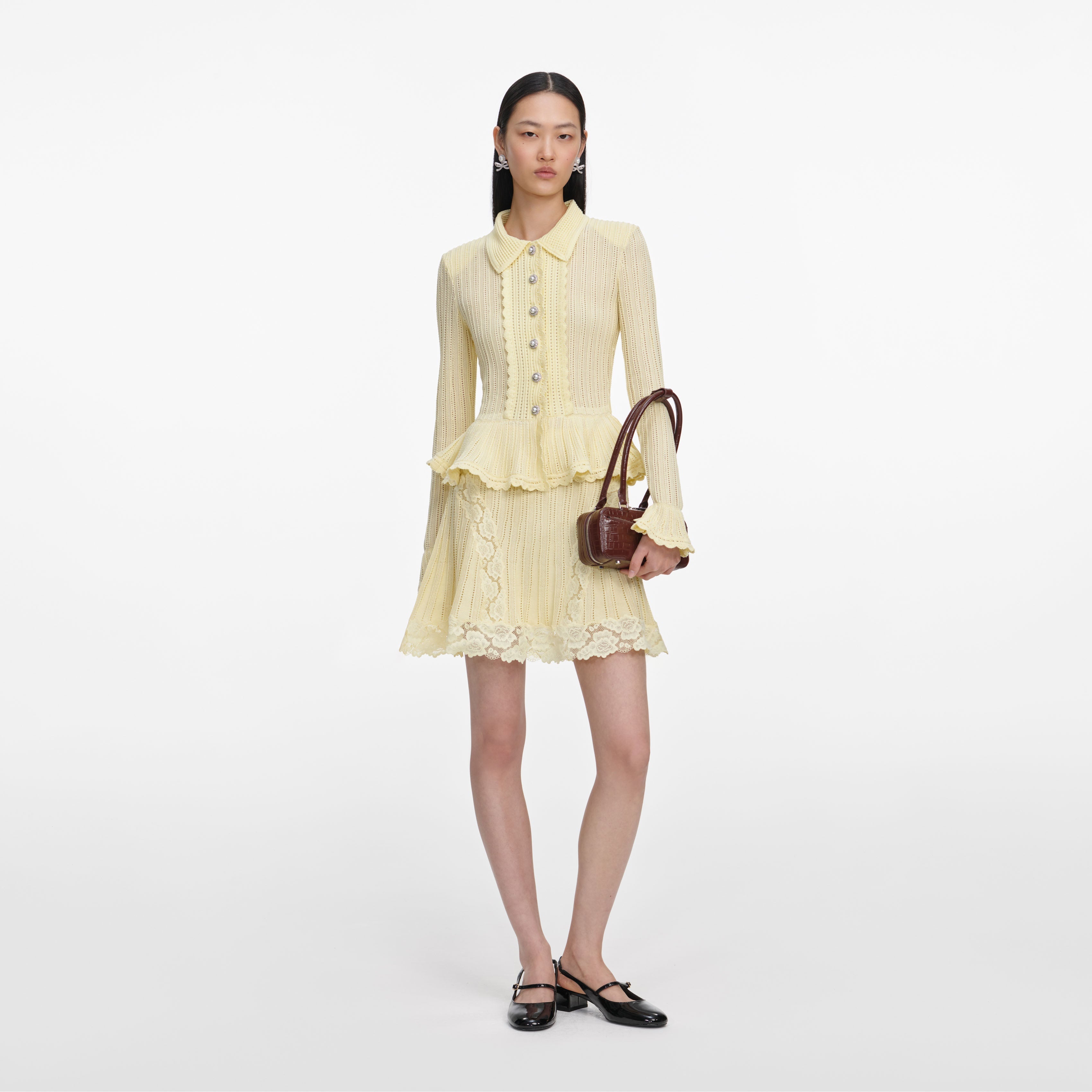 Front view of a woman wearing the Yellow Pointelle Peplum Knit Mini Dress
