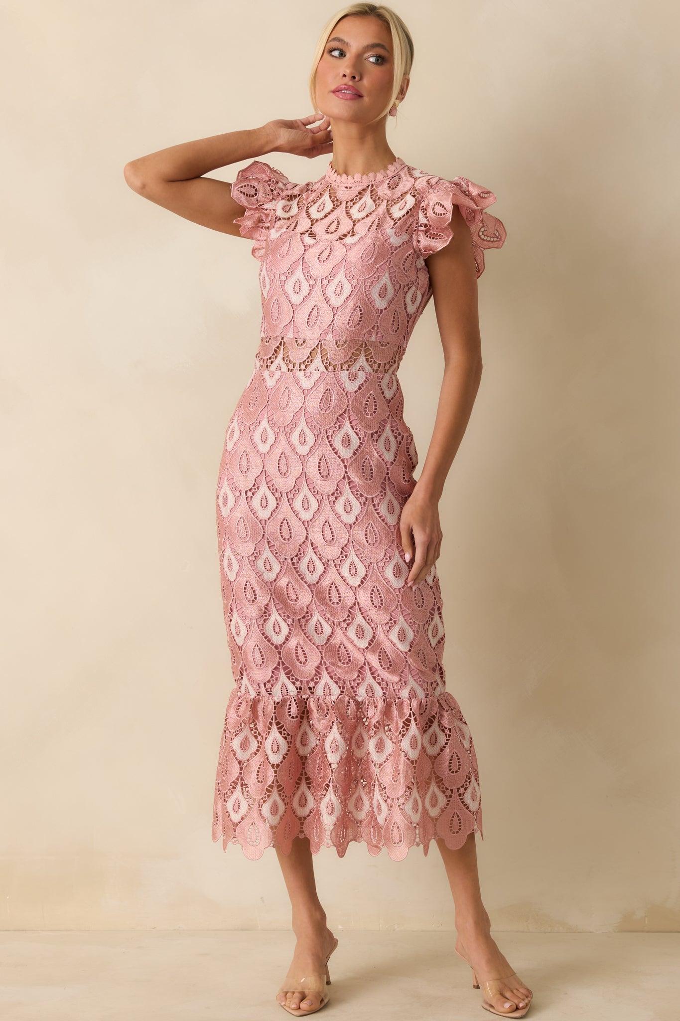 The dress displays the soft pink lace with elegant flounce, sheer detailing, and structured bodice shape.