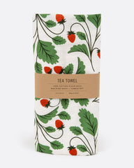 A tea towel with a strawberry pattern. Shown folded in its paper wrapping.