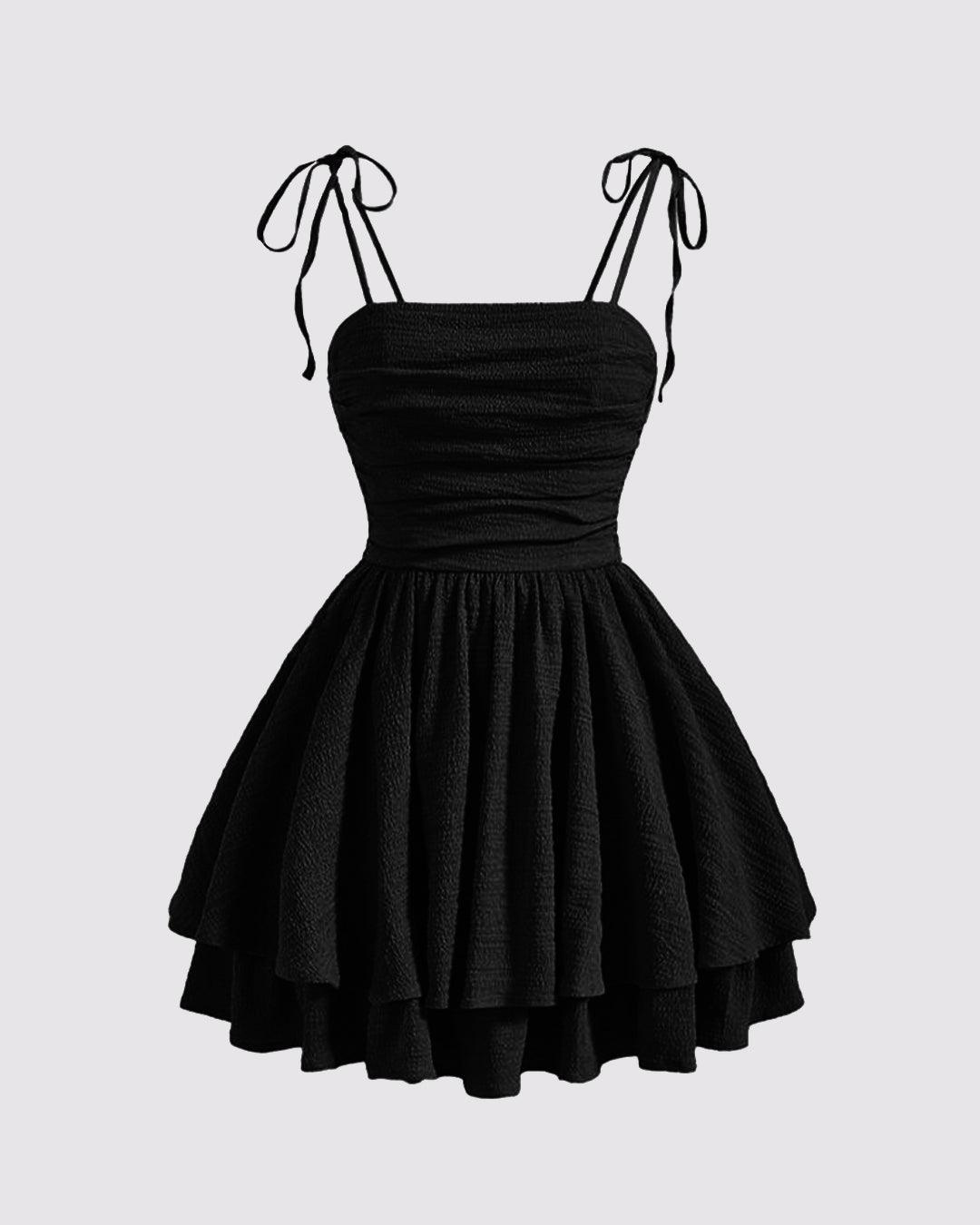 Front view of Black tie-shoulder cami mini dress with ruched bodice and layered skirt, shown front and back.