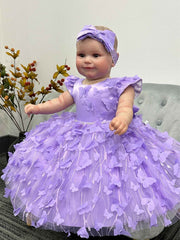 Baby in a purple dress with a matching headband for a special occasion.