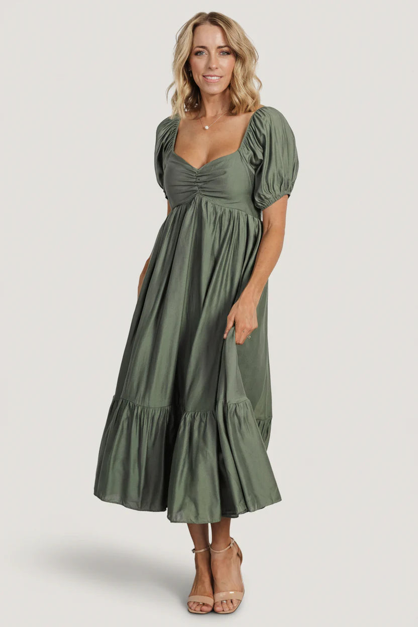 Front studio view of the Annalisa midi dress in dusty olive showing wide sweetheart neckline, smocked back, and tiered midi skirt.