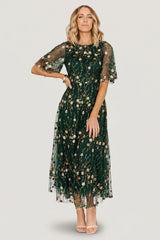Front view of Arabella dark green embroidered tulle maxi dress with gold and ivory floral embroidery, round neckline, and layered skirt.