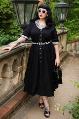 A model wearing a Mollie Black Full Circle Shirt Dress With Gingham