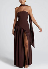 Model wearing espresso brown strapless maxi dress with crepe bodice, white chiffon skirt, thigh-high slit, and matching chiffon scarf.