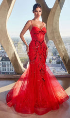 A woman stands indoors by large windows overlooking the city, wearing the Ladivine CM352—a long red beaded mermaid prom dress.