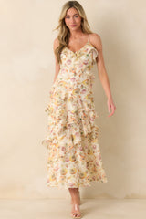 A full body front view of the ivory maxi dress with a yellow multicolor floral print and v-neckline.