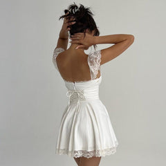 White lace-trimmed mini dress with open back.
