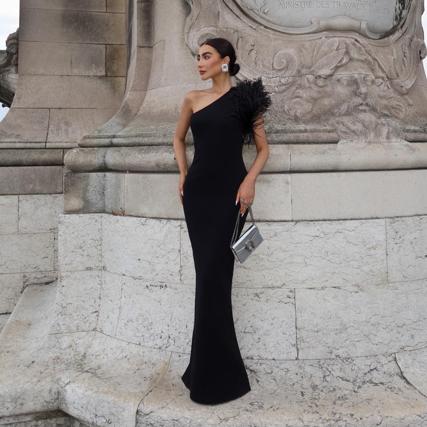 one-shoulder black gown with feather detail, evening look