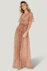 Front view of a nude-rose vine-embossed organza maxi dress with surplice neckline and elastic waist, displayed on a mannequin.