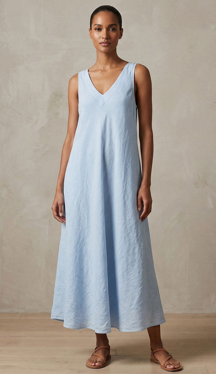 Woman wearing Milio Milano Italian linen light blue sleeveless dress against a neutral background